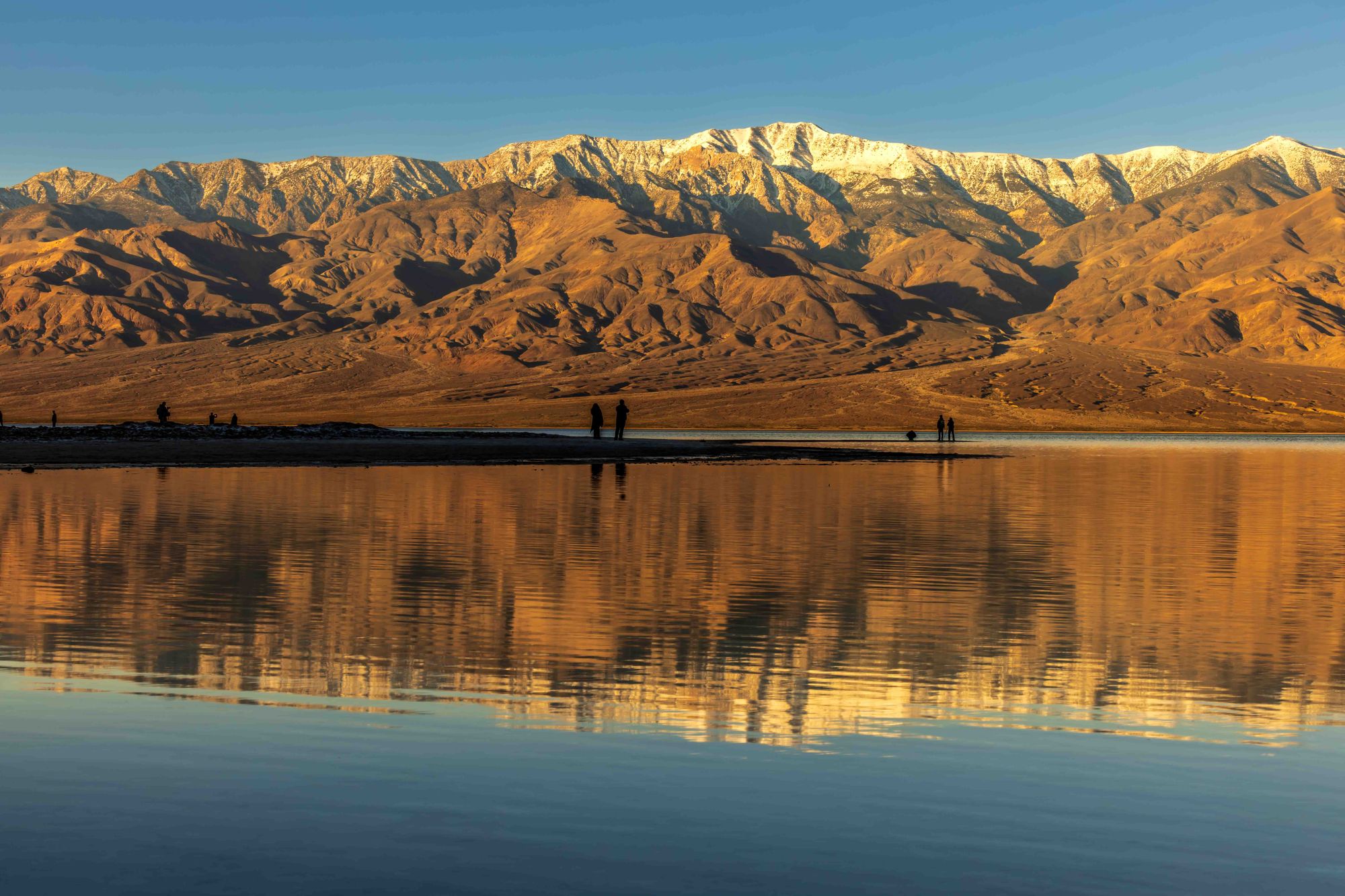 Death Valley ridges, salt flats, and distant peaks under fading desert light